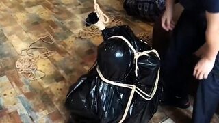 The girl struggled in the garbage bag.