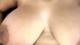 A super sexy brunette massages her big boobs