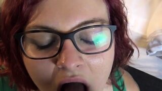 Woman with glasses blows black cock
