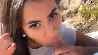 Cute latina blows and plays with her shaved pussy outdoors